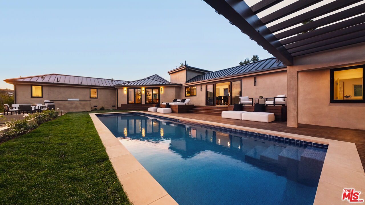 13146 Rivers Road Los Angeles, CA 90049 - Photo 36 of 42 a view of a house with a swimming pool