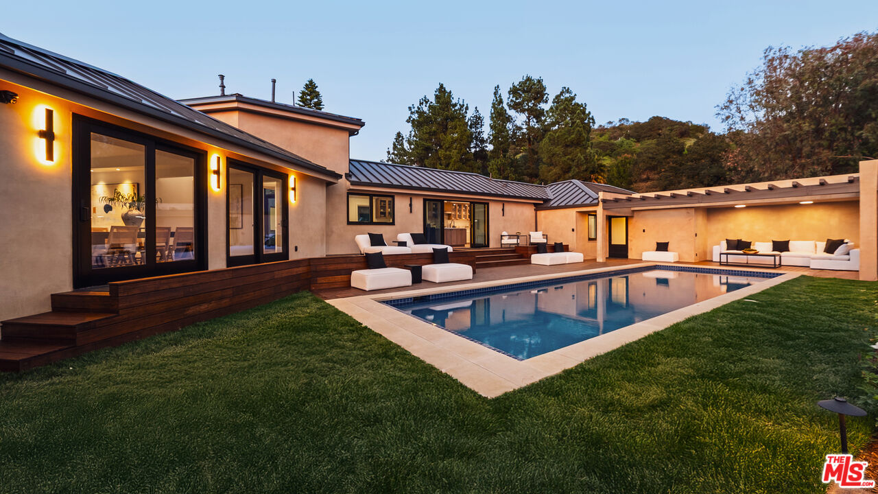 13146 Rivers Road Los Angeles, CA 90049 - Photo 37 of 42 a view of a house with swimming pool and porch