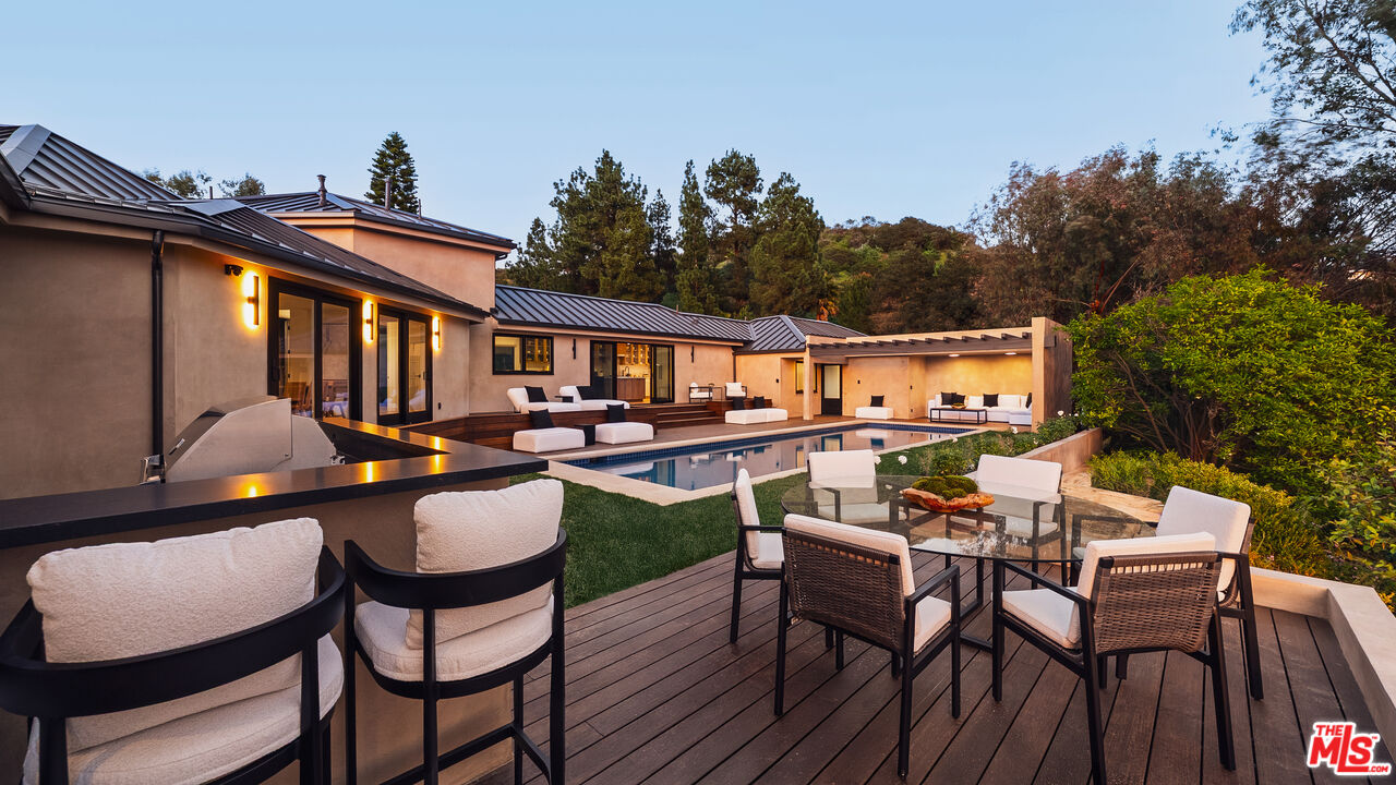 13146 Rivers Road Los Angeles, CA 90049 - Photo 38 of 42 a backyard of a house with outdoor seating