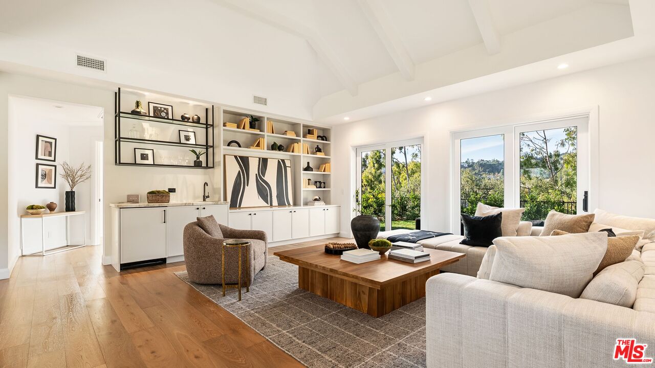 13146 Rivers Road Los Angeles, CA 90049 - Photo 4 of 42 a living room with furniture kitchen view and large windows