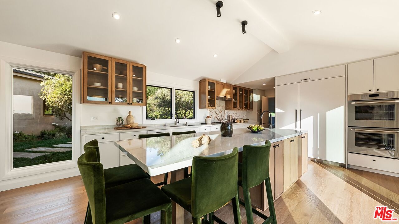13146 Rivers Road Los Angeles, CA 90049 - Photo 8 of 42 a dining room with stainless steel appliances a table and chairs