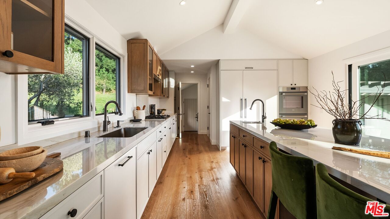 13146 Rivers Road Los Angeles, CA 90049 - Photo 9 of 42 a large kitchen with a large window and stainless steel appliances