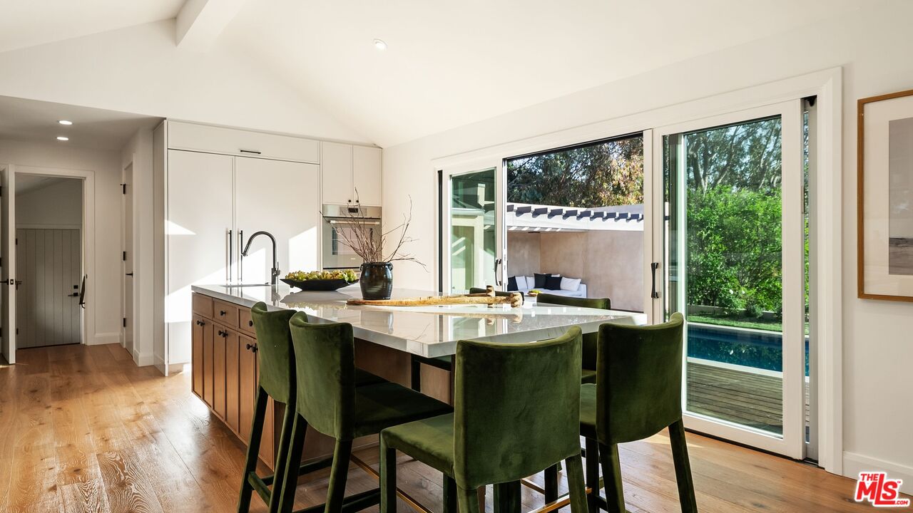 13146 Rivers Road Los Angeles, CA 90049 - Photo 10 of 42 a view of a dining room with furniture and wooden floor
