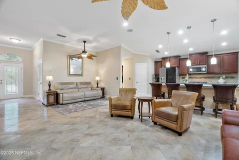 a kitchen with kitchen island granite countertop wooden cabinets and a refrigerator