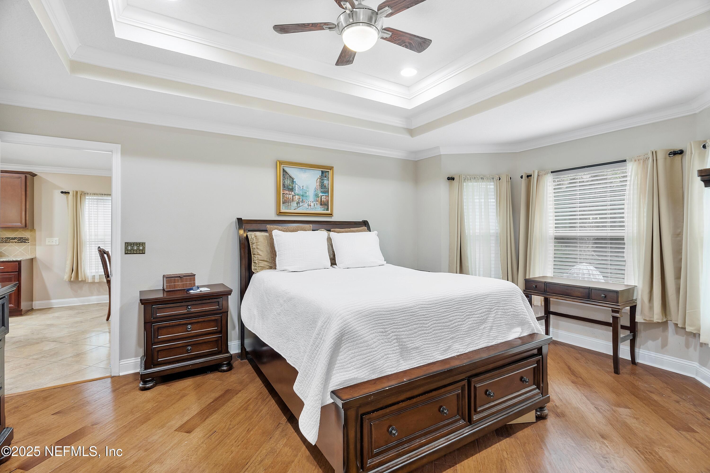 78 Wayfare Lane Jacksonville, FL 32081 - Photo 20 of 61 a bedroom with a bed and a chandelier