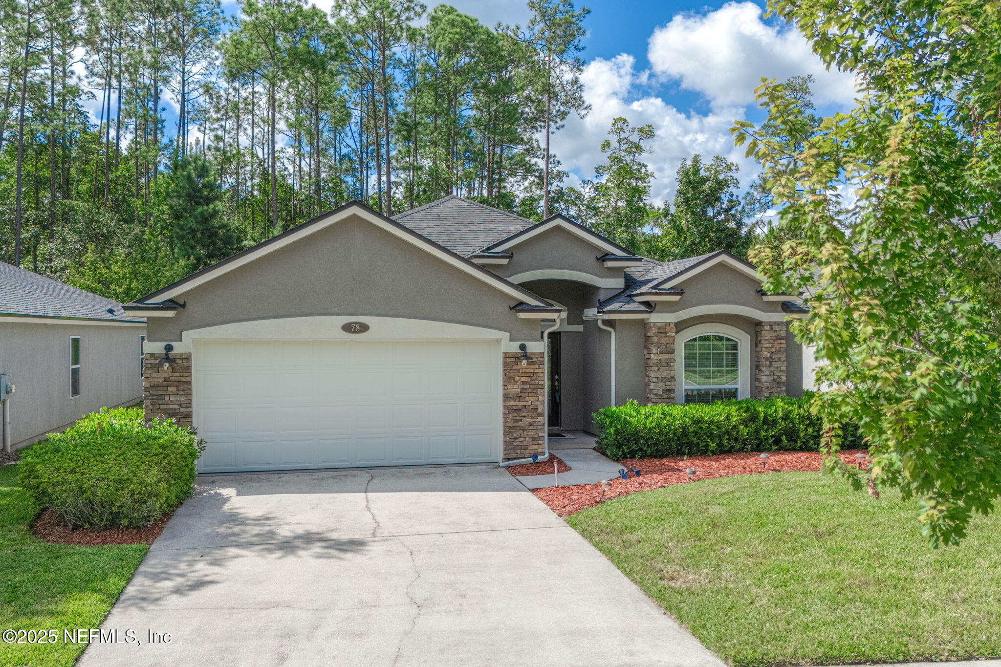 78 Wayfare Lane Jacksonville, FL 32081 - Photo 2 of 61 a white house with a small yard and big trees