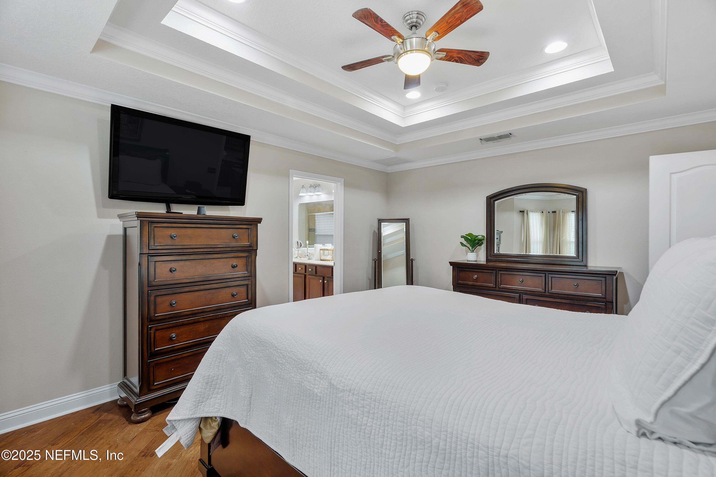 78 Wayfare Lane Jacksonville, FL 32081 - Photo 21 of 61 a bedroom with a bed and a flat screen tv