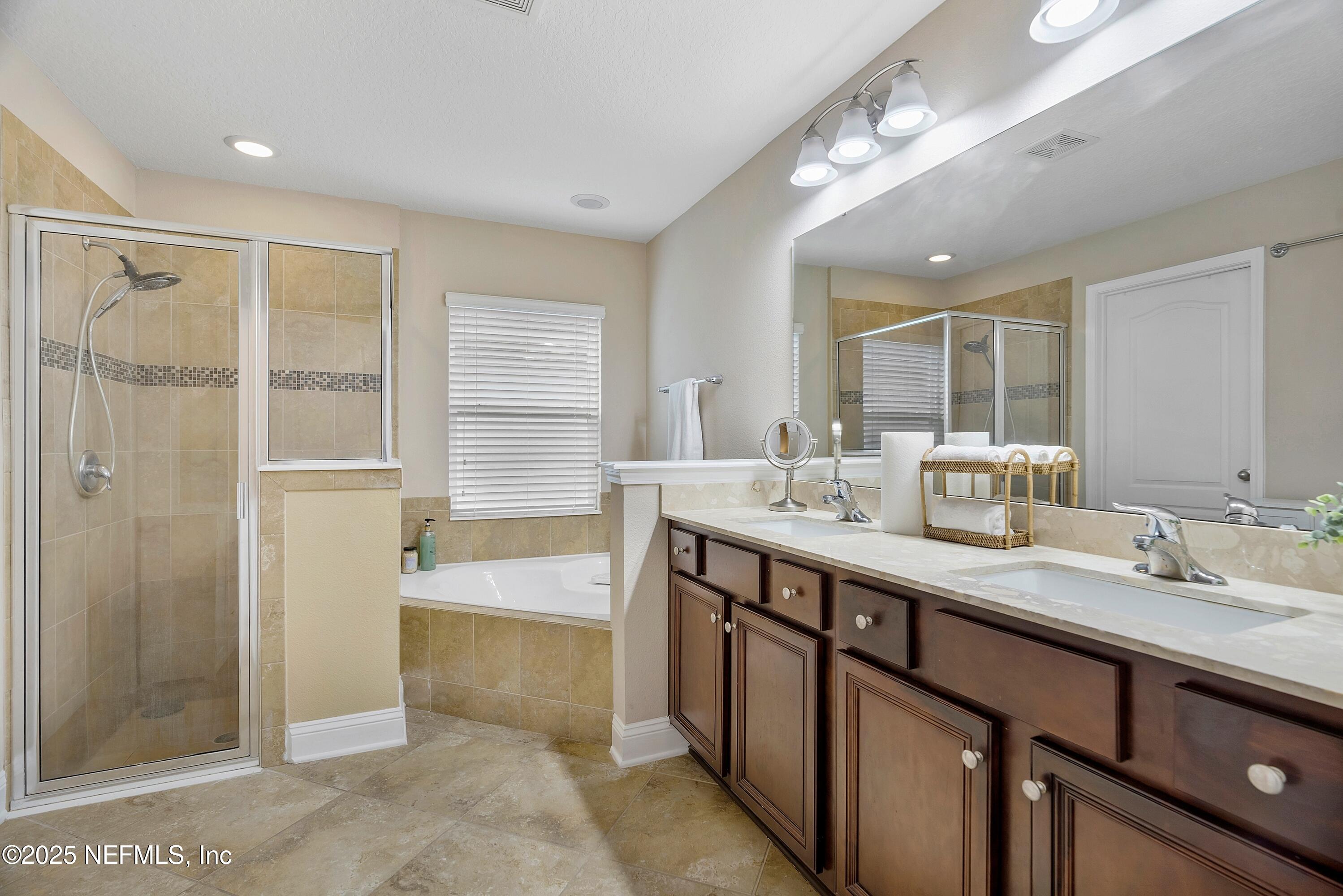 78 Wayfare Lane Jacksonville, FL 32081 - Photo 22 of 61 a bathroom with a double vanity sink a large mirror and a shower