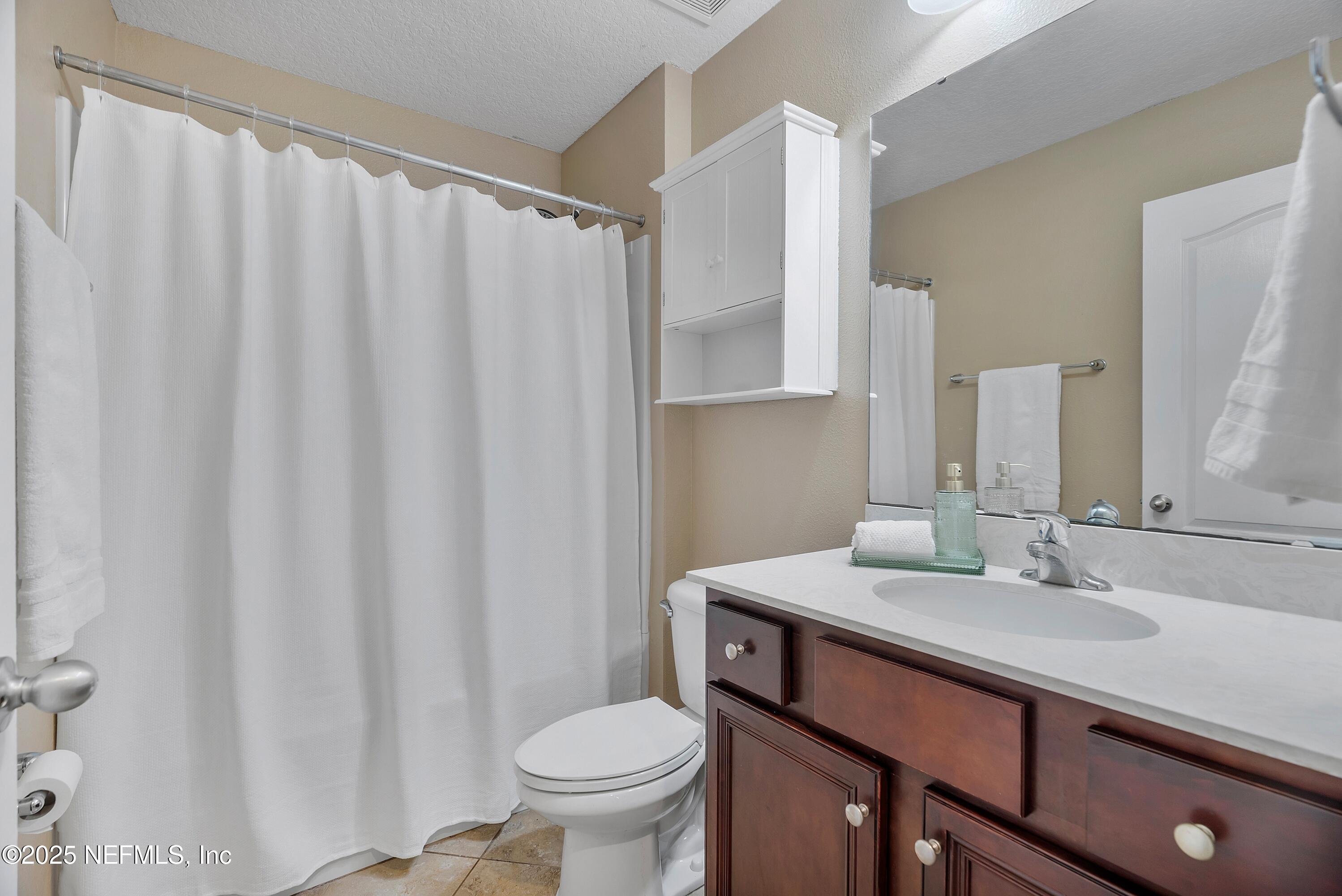 78 Wayfare Lane Jacksonville, FL 32081 - Photo 24 of 61 a bathroom with a sink a toilet and a mirror