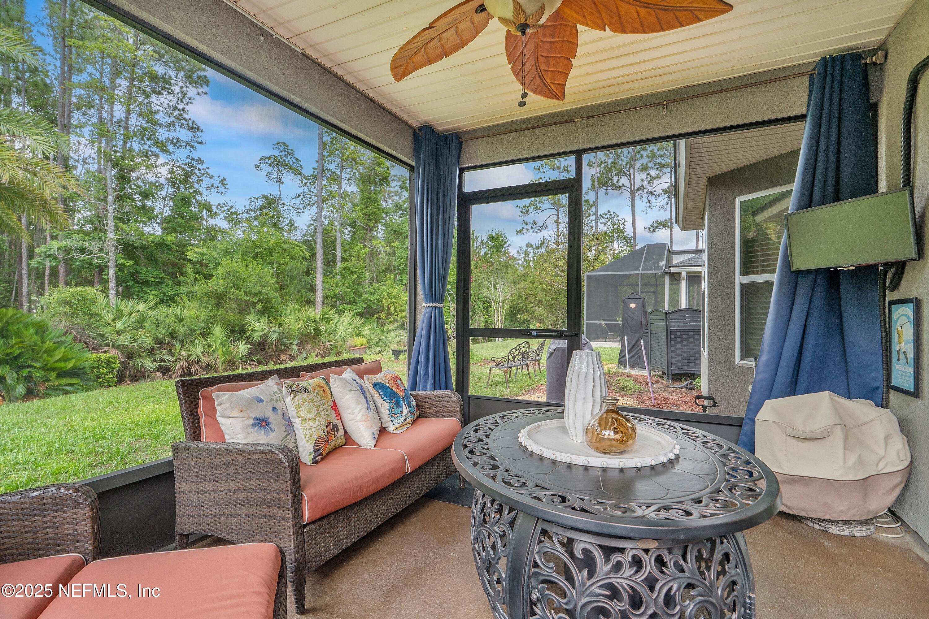 78 Wayfare Lane Jacksonville, FL 32081 - Photo 27 of 61 a living room with patio furniture and a floor to ceiling window