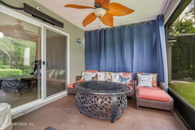 a view of a chair and table in backyard of the house