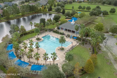 a view of a patio with chairs under an umbrella