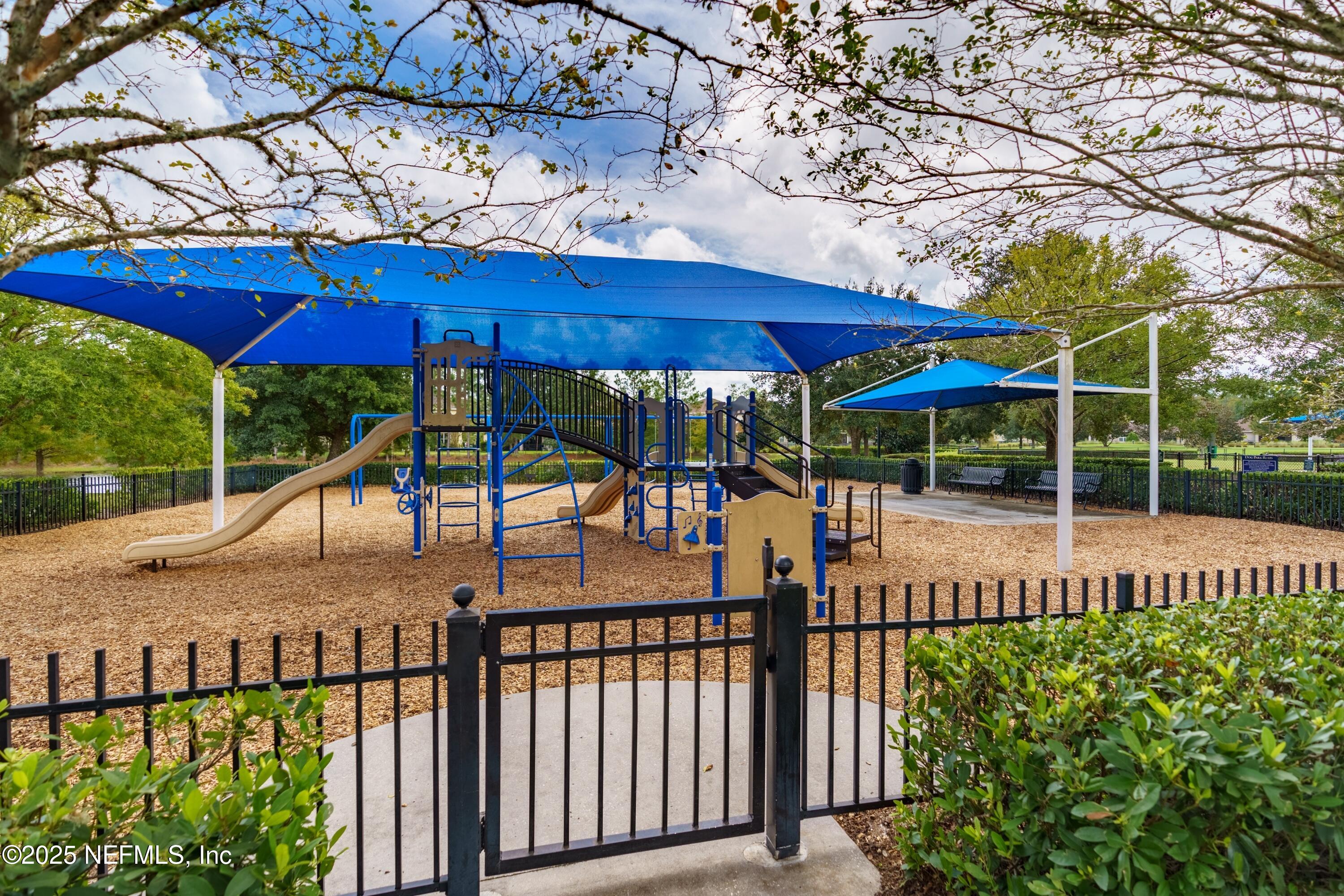 78 Wayfare Lane Jacksonville, FL 32081 - Photo 43 of 61 a view of a patio with chairs under an umbrella