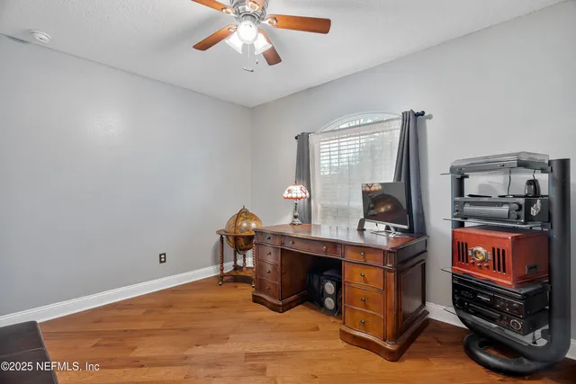 a living room with furniture a dining table and a chandelier