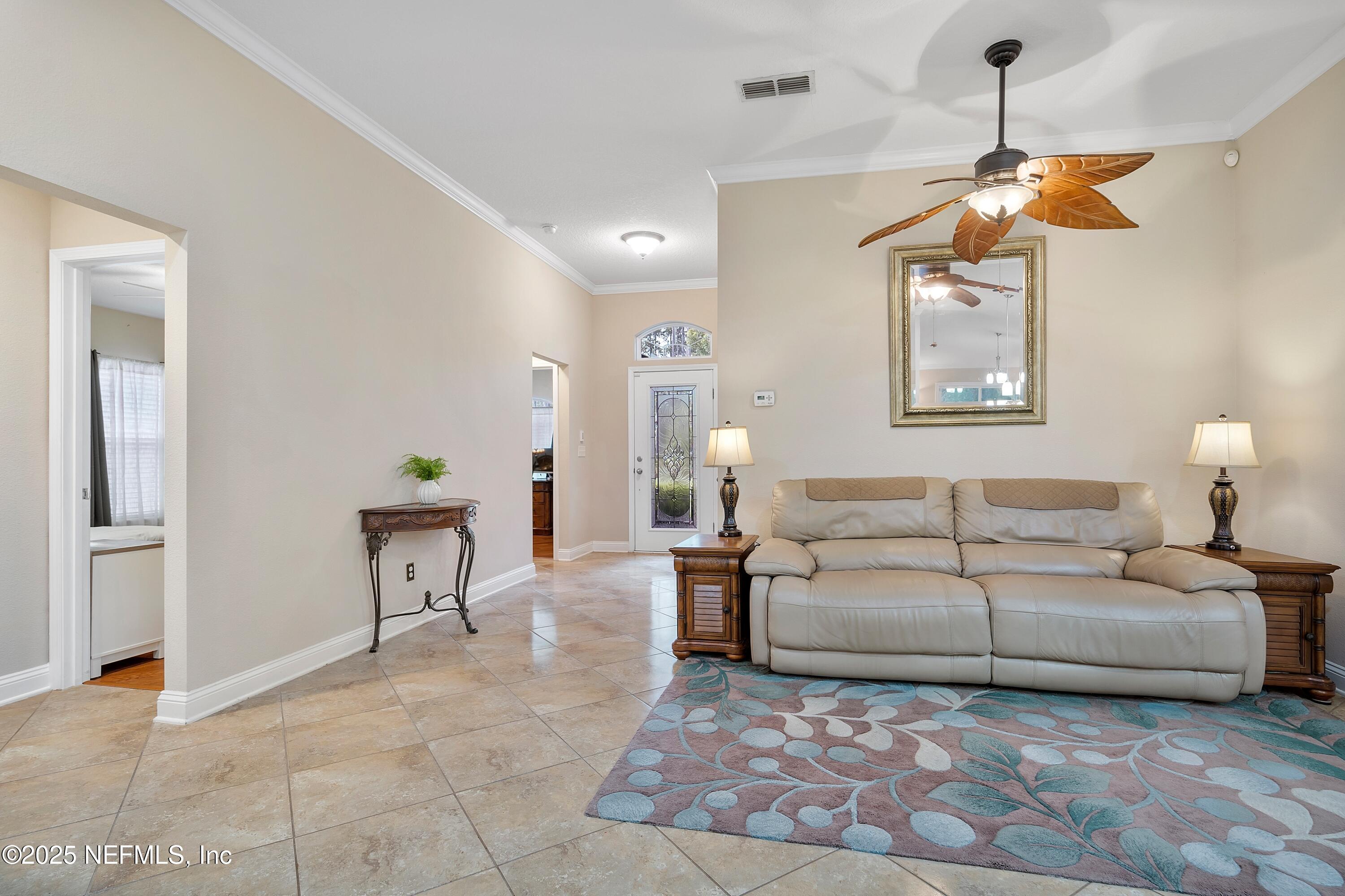 78 Wayfare Lane Jacksonville, FL 32081 - Photo 8 of 61 a living room with furniture a dining table and a chandelier