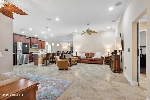 a living room with furniture and kitchen view