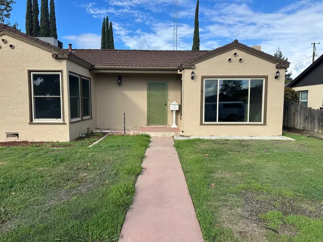 a front view of a house with a yard