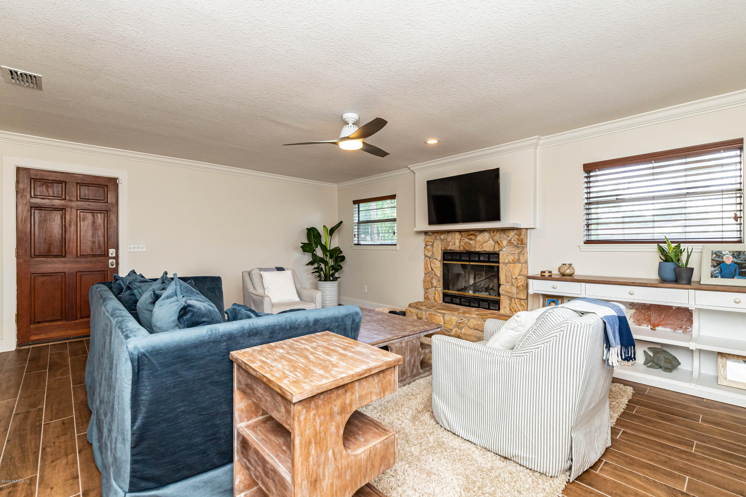 20 Amberjack Road Ponte Vedra Beach, FL 32082 - Photo 15 of 37 a living room with furniture a flat screen tv and a fireplace
