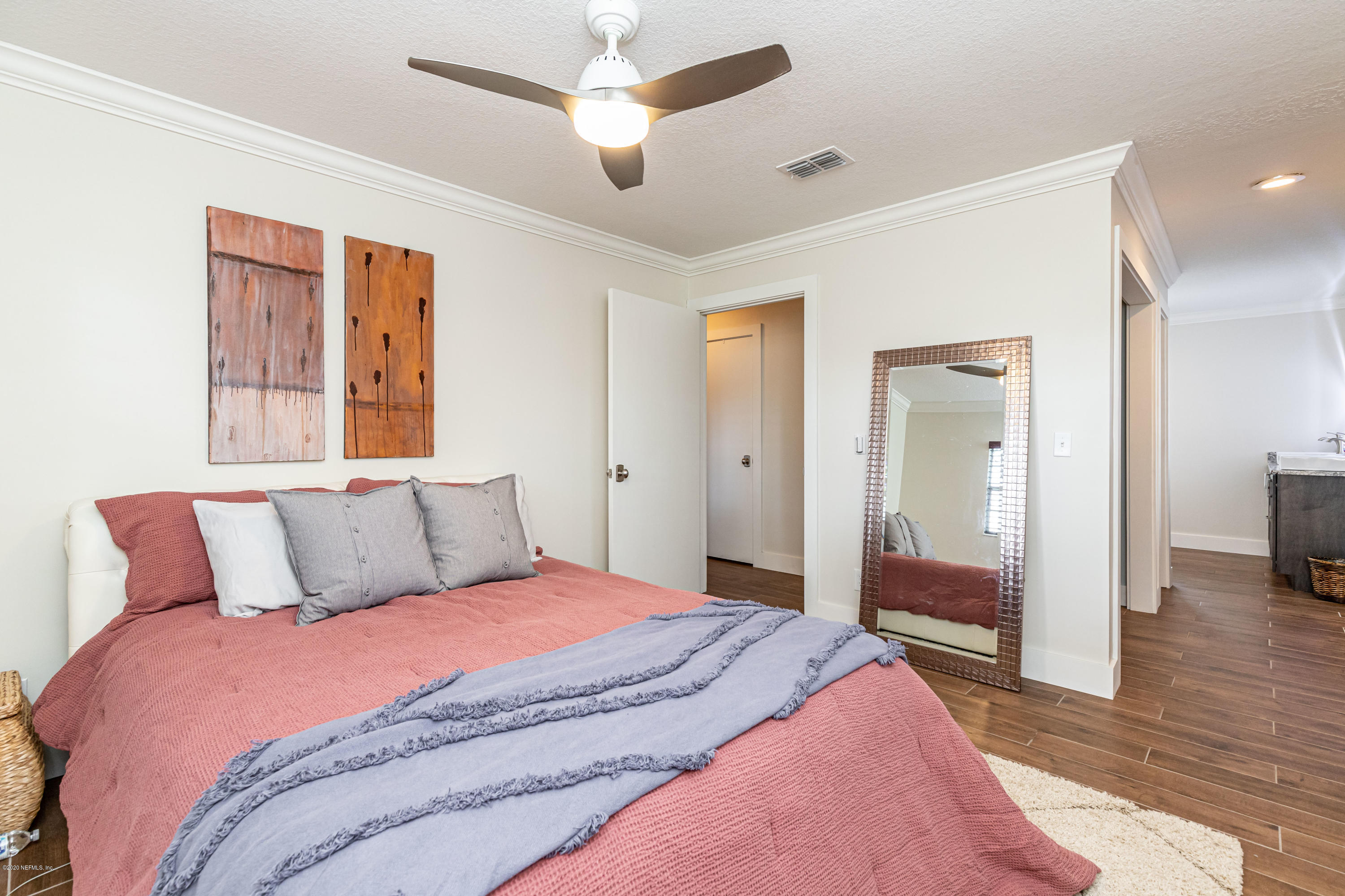 20 Amberjack Road Ponte Vedra Beach, FL 32082 - Photo 20 of 37 a bedroom with a large bed and a chandelier