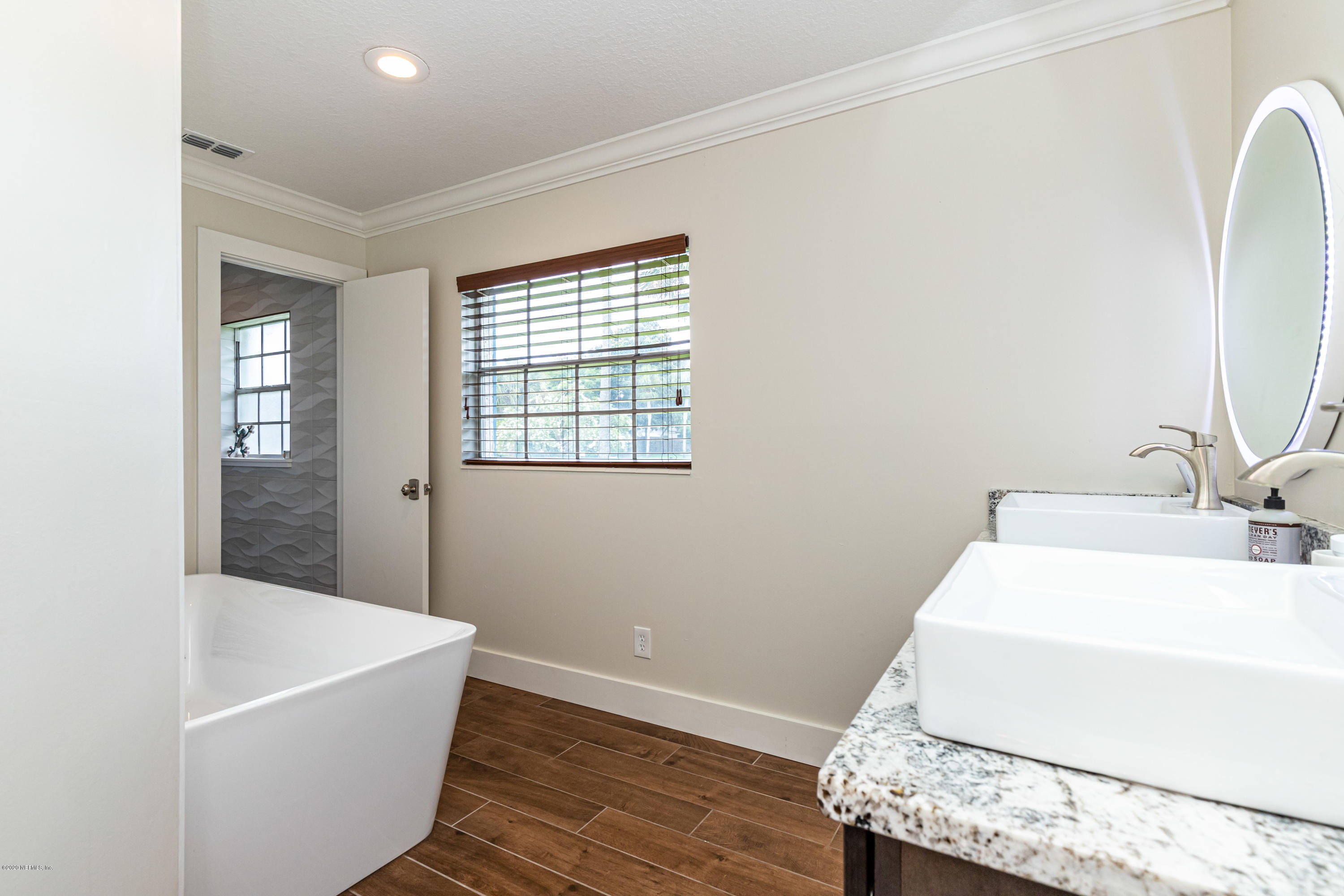 20 Amberjack Road Ponte Vedra Beach, FL 32082 - Photo 22 of 37 a bathroom with a granite countertop sink and a bathtub