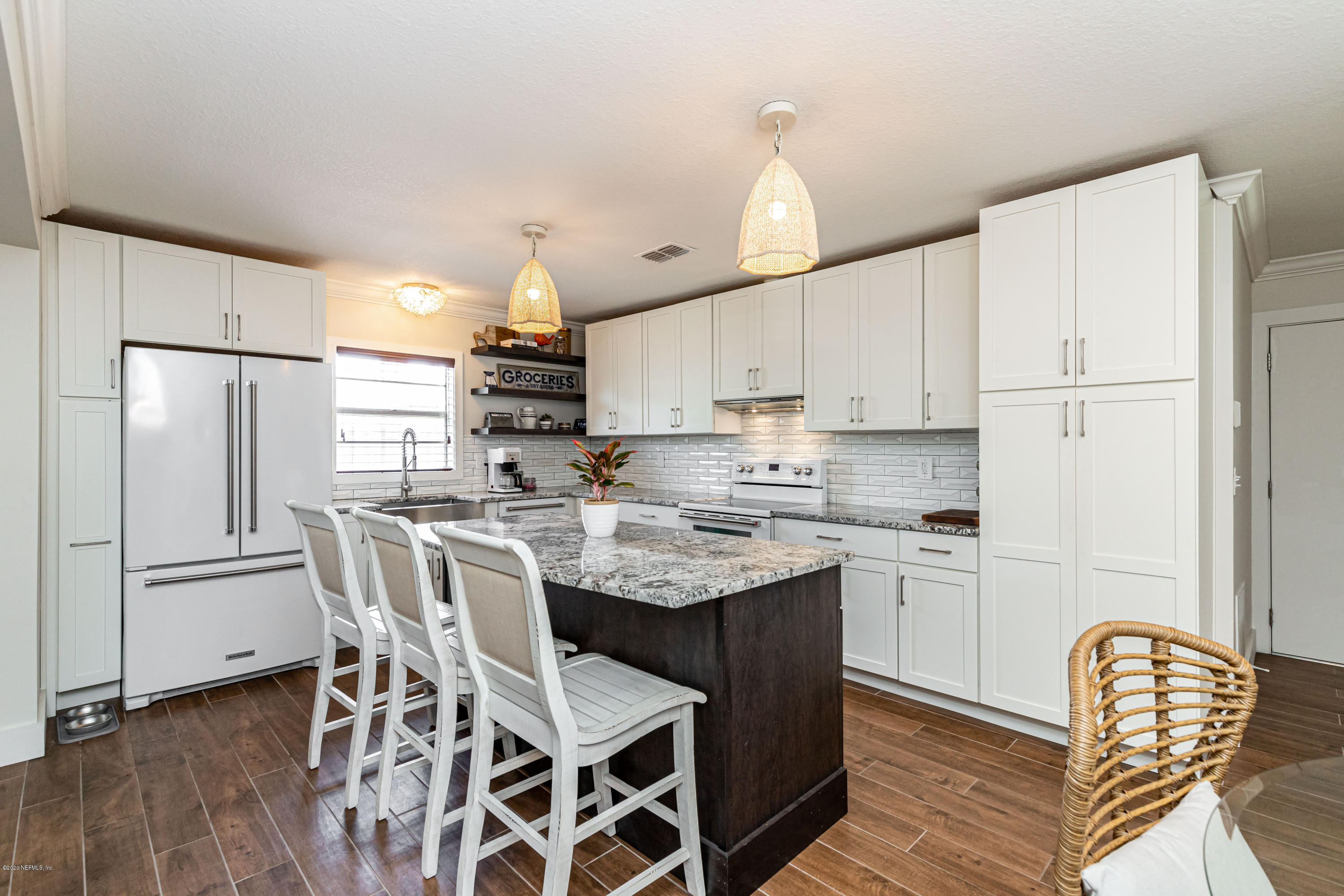 20 Amberjack Road Ponte Vedra Beach, FL 32082 - Photo 8 of 37 a kitchen with kitchen island granite countertop a sink a center island and stainless steel appliances