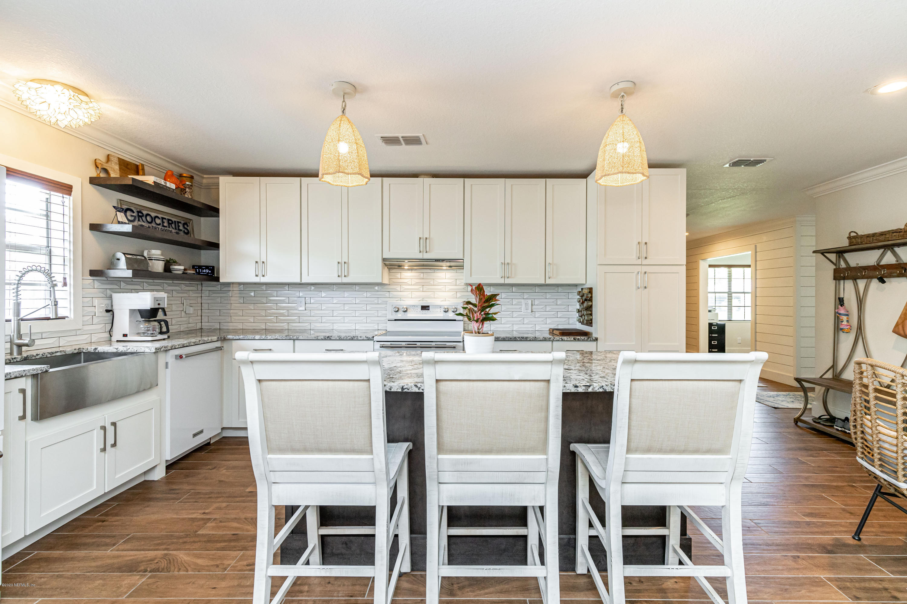 20 Amberjack Road Ponte Vedra Beach, FL 32082 - Photo 9 of 37 a kitchen with a white cabinets and chairs in it