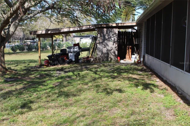 a backyard of a house with table and chairs