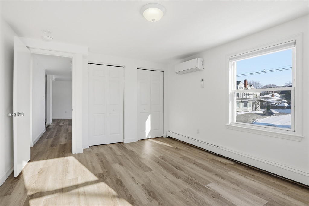 381 South Main Street, Unit 2 Haverhill, MA 01835 - Photo 11 of 18 a view of an empty room with wooden floor and a window