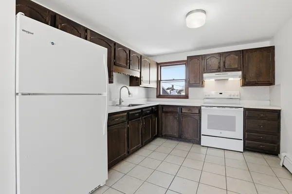 a kitchen with a sink a stove and refrigerator
