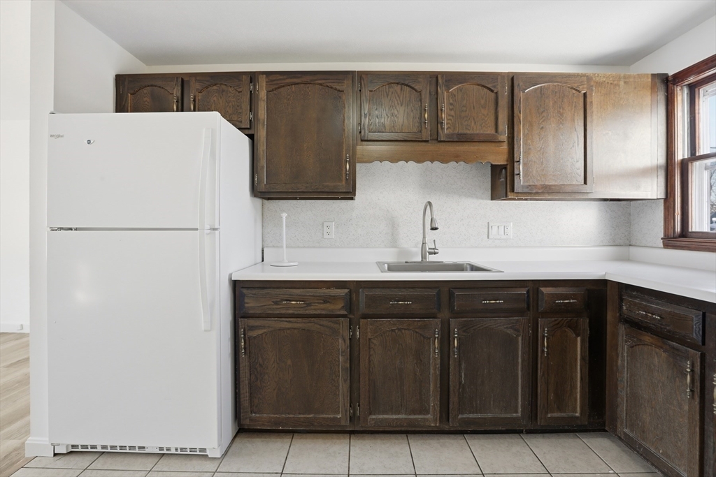 381 South Main Street, Unit 2 Haverhill, MA 01835 - Photo 7 of 18 a kitchen with a sink and a refrigerator