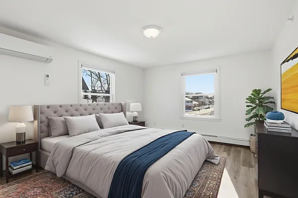 a bedroom with a bed and a potted plant