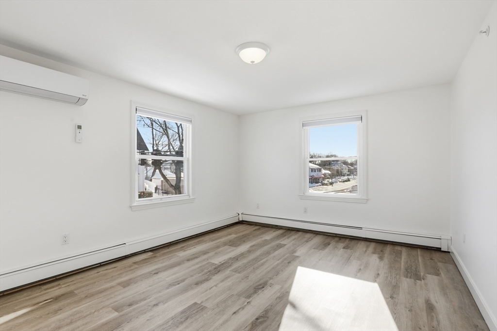 381 South Main Street, Unit 2 Haverhill, MA 01835 - Photo 10 of 18 a view of an empty room with wooden floor and a window