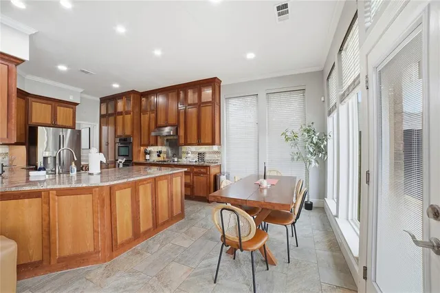 a large kitchen with lots of counter space a sink appliances and cabinets