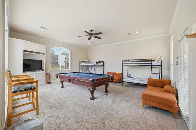 a living room with furniture pool table and flat screen tv