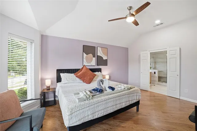 a large bathroom with a double vanity sink a large mirror and a bathtub