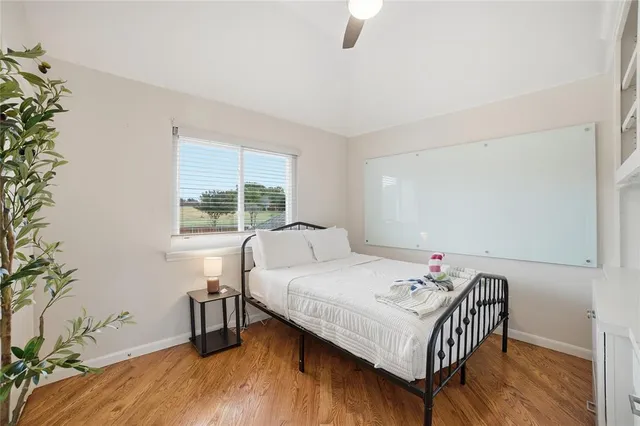 a bedroom with a bed and a large window