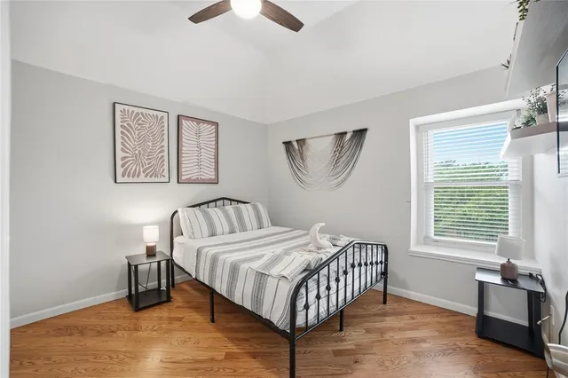a bathroom with a granite countertop sink a mirror a toilet and shower