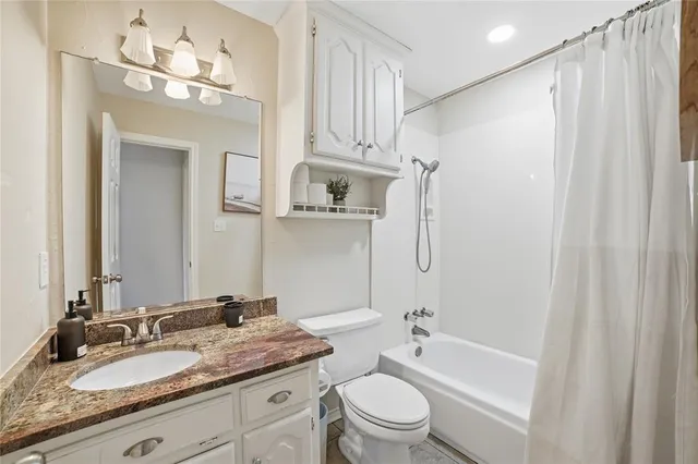 a view of a swimming pool with a chairs and table in the patio