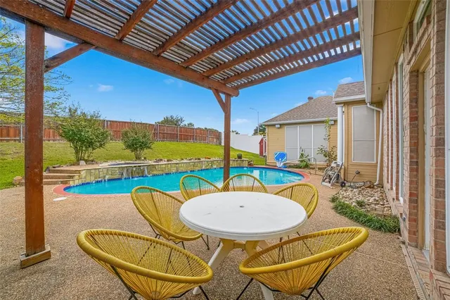 a view of a swimming pool with an outdoor space and seating area