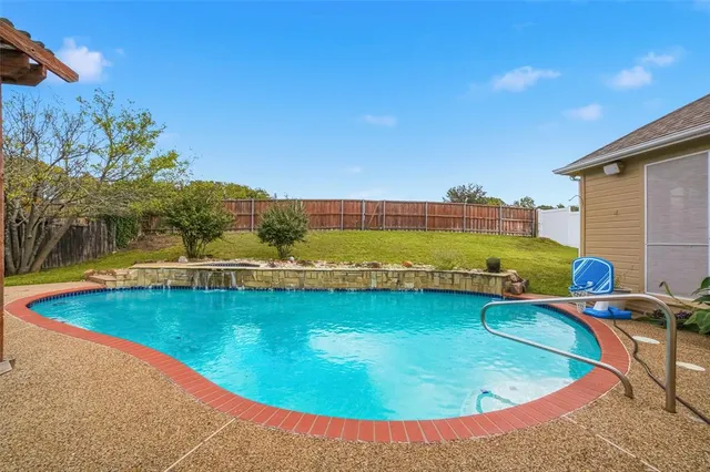 a front view of a house with a garden and yard