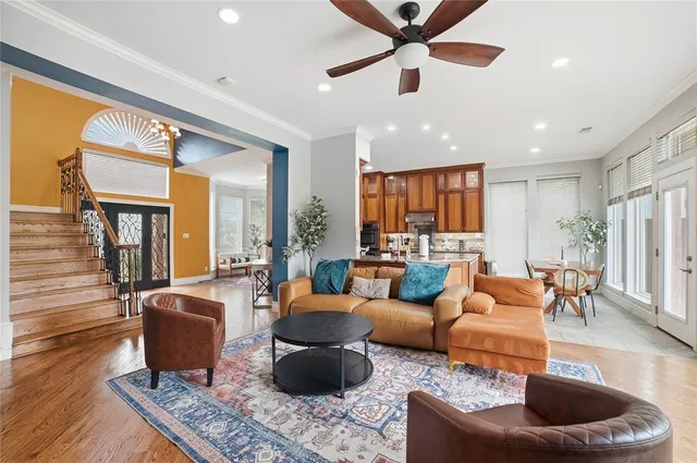 a living room with furniture a fireplace and a floor to ceiling window