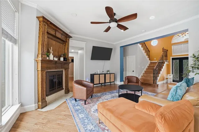 a living room with furniture fireplace and a large window