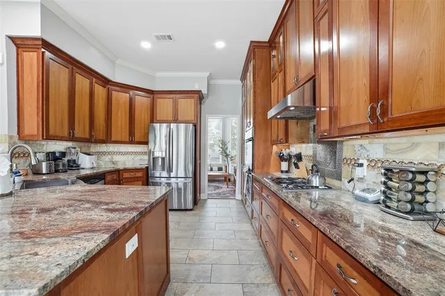 a kitchen with stainless steel appliances granite countertop a sink and cabinets