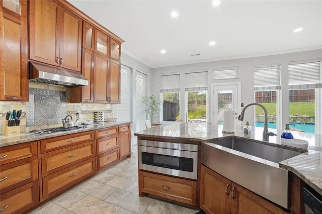 a kitchen with a stove a sink and a refrigerator