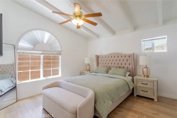 a bedroom with a bed and a large window