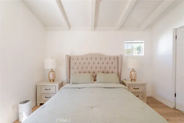 a bedroom with a bed and a lamp