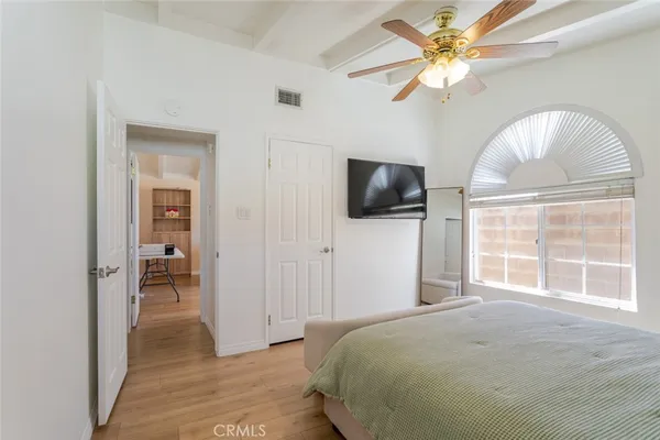 a bedroom with a bed and a flat screen tv
