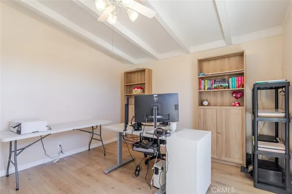 a work room with furniture and wooden floor