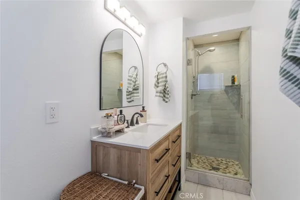 a bathroom with a sink a mirror and a shower