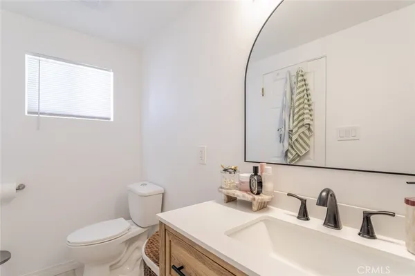 a bathroom with a sink a toilet and mirror